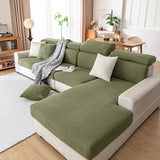 Olive green corduroy cushion covers fitted on a chaise sectional with a woven throw over the arm