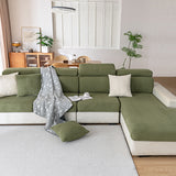 Olive green corduroy cushion covers across a full sectional including the chaise section