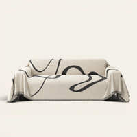 Abstract Haze Abstract Muse sofa throw draped over a full couch, front view on ivory background