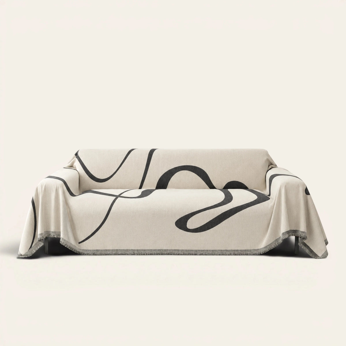 Abstract Haze Abstract Muse sofa throw draped over a full couch, front view on ivory background