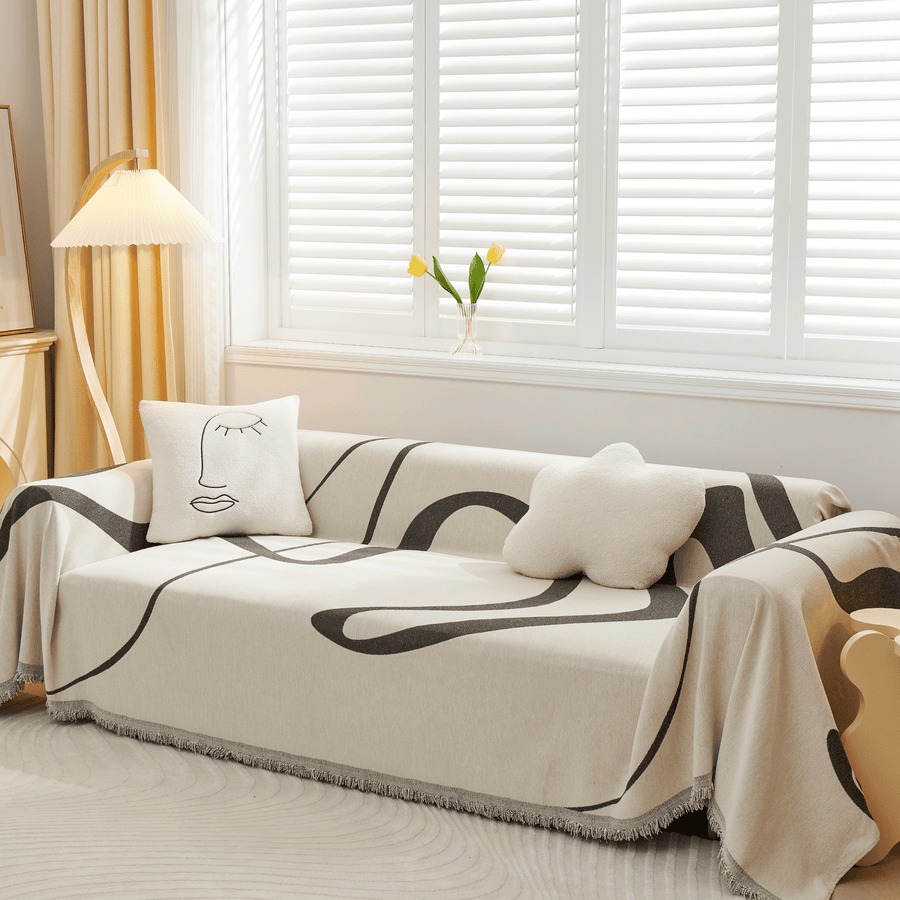 Abstract Haze Abstract Muse throw over a corner sofa with face and star cushions