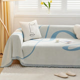 Azure Flow Abstract Muse throw styled in a bright living room with a line-art cushion, candle and magazine