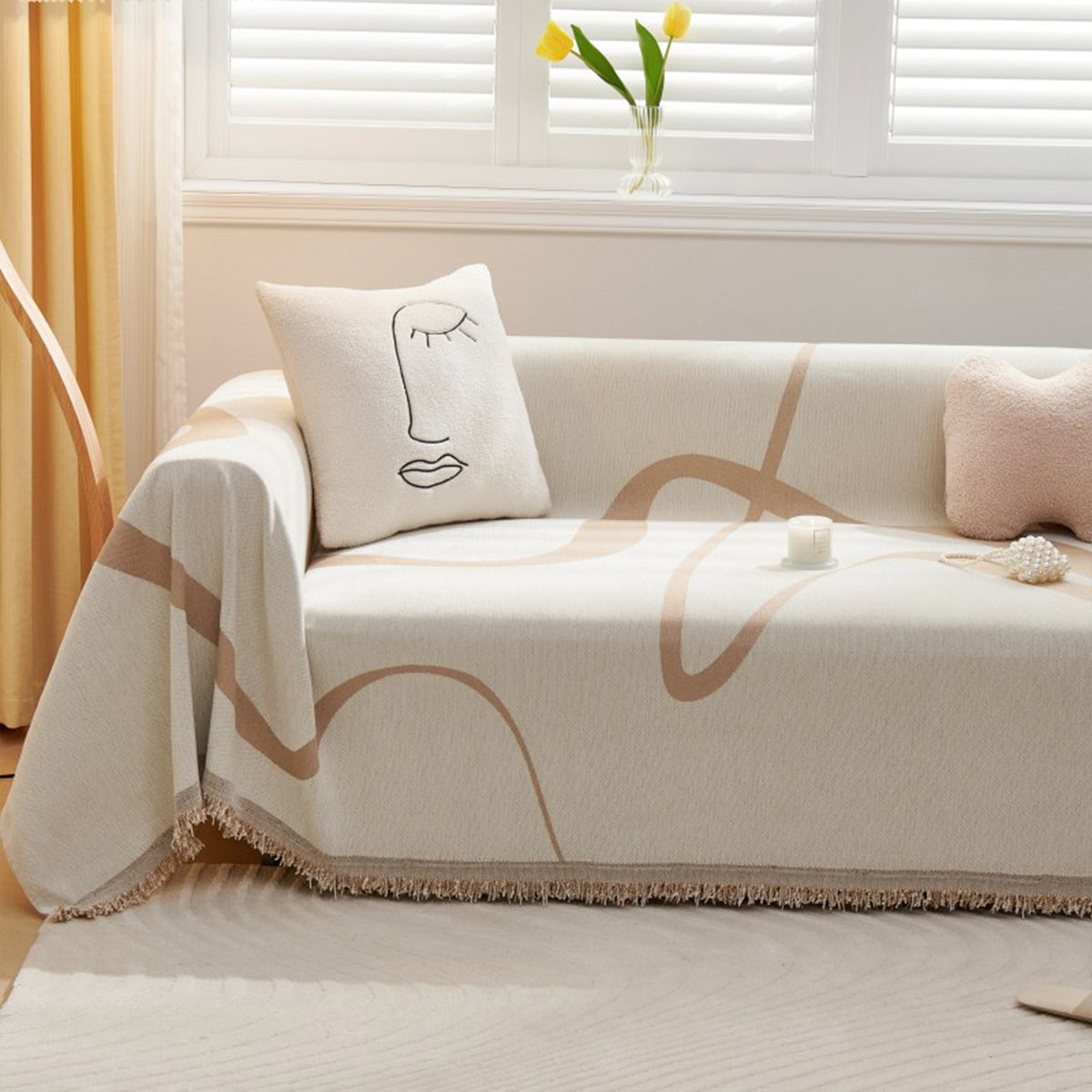 Earth trace Abstract Muse throw styled on a sofa with a line-art cushion and tulips by a window