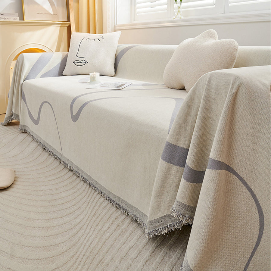 Abstract Muse Monochrome Wave throw draped over the sofa corner, angled living room view