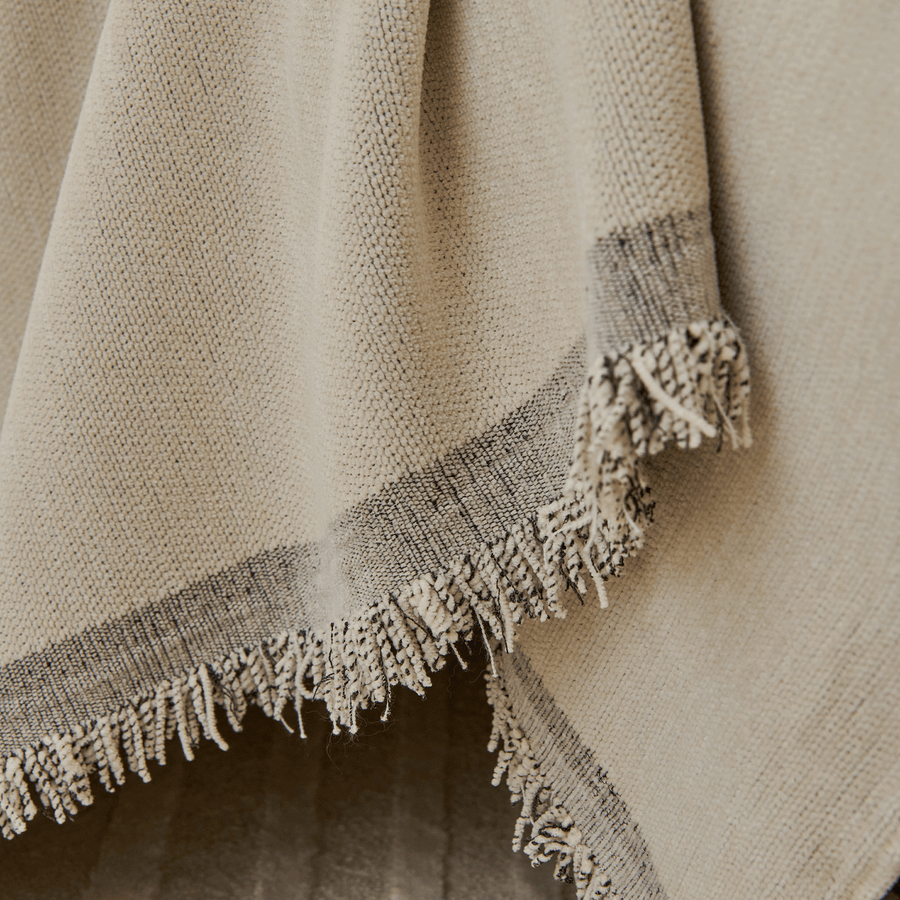 Close-up of the grey bordered fringed edge of the Abstract Muse Monochrome Wave throw