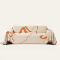 Sunset Stream Abstract Muse sofa throw draped over a full couch, front view on ivory background