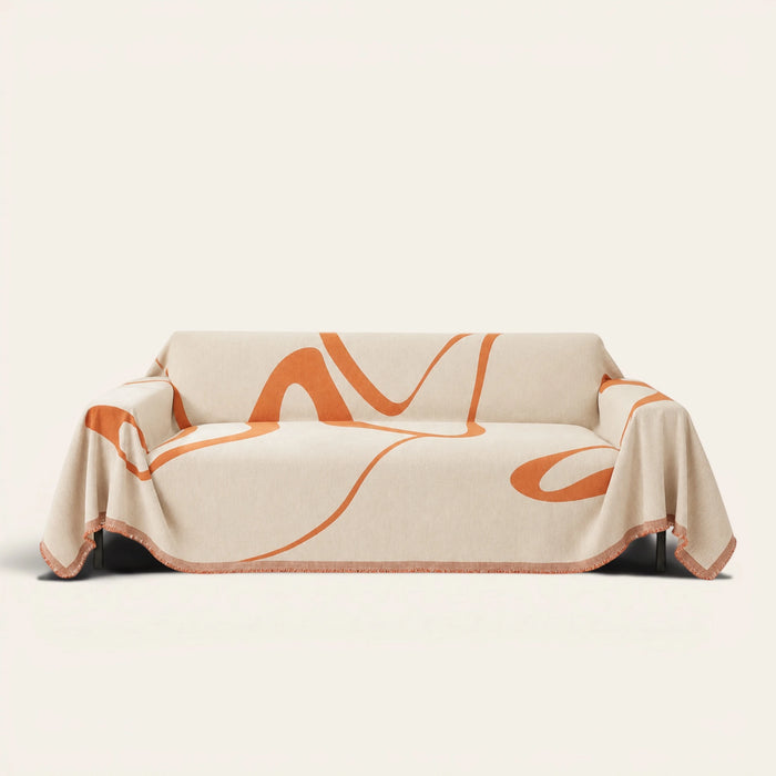 Sunset Stream Abstract Muse sofa throw draped over a full couch, front view on ivory background