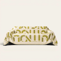 Whispering Fern Abstract Narratives sofa throw draped over a full couch, front view on ivory background