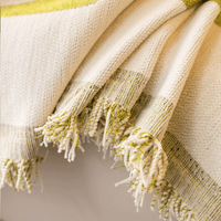 Close-up of the Whispering Fern Abstract Narratives fringed edge in olive green and cream