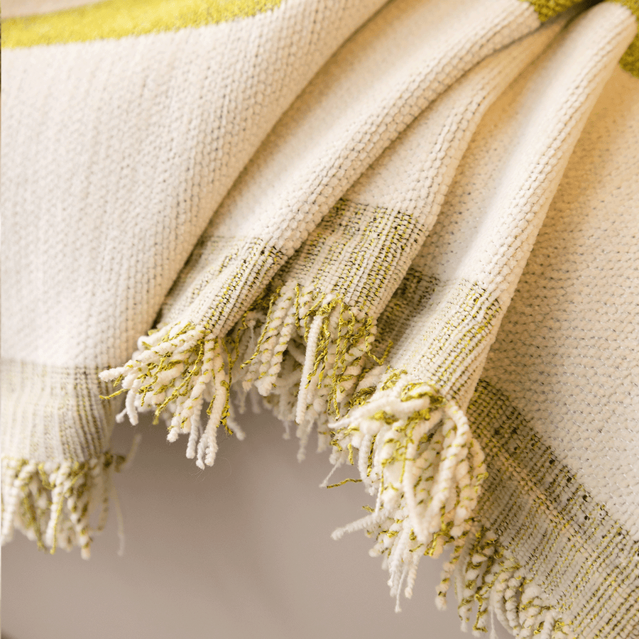 Close-up of the Whispering Fern Abstract Narratives fringed edge in olive green and cream