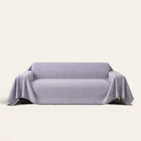 Misty Gray Arcane Ambiance sofa throw draped over a two-seat sofa, front view on ivory background, arched line pattern