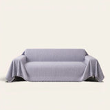 Misty Gray Arcane Ambiance sofa throw draped over a two-seat sofa, front view on ivory background, arched line pattern