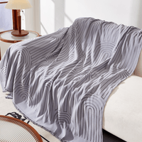 Misty Gray Arcane Ambiance throw cascading over a sofa corner, arched lines flowing beside a lamp