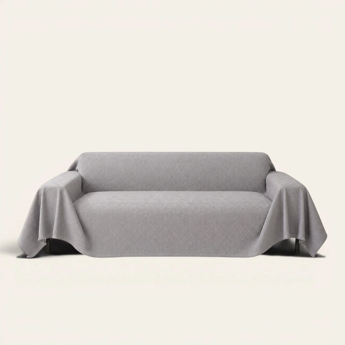 Graphite mist Artisan Cooling sofa throw in soft gray with an embossed geometric texture, front view on ivory