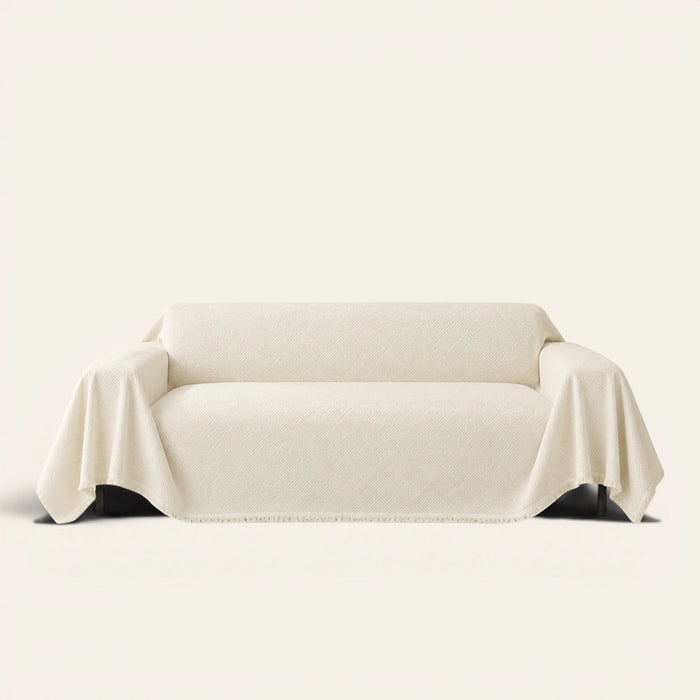 Artisan Cooling sofa throw in Ivory Cloud draped over a couch, front view on ivory background
