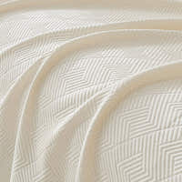 Macro of the Ivory Cloud fabric showing the Artisan Cooling woven geometric texture