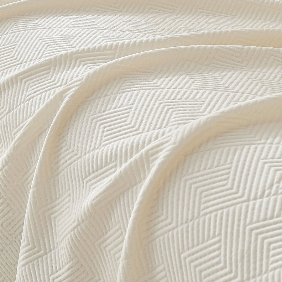 Macro of the Ivory Cloud fabric showing the Artisan Cooling woven geometric texture