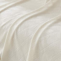 Close-up of the Ivory Cloud Artisan Cooling throw, detail of the quilted chevron weave