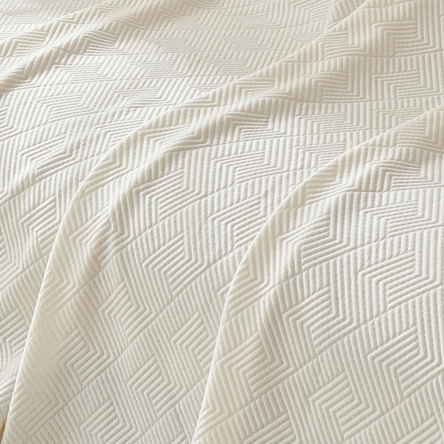 Close-up of the Ivory Cloud Artisan Cooling throw, detail of the quilted chevron weave