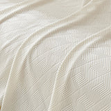 Close-up of the Ivory Cloud Artisan Cooling throw, detail of the quilted chevron weave