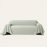 Mint Veil Artisan Cooling sofa throw draped over a two-seat sofa, front view on ivory background, quilted geometric texture