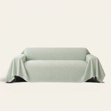 Mint Veil Artisan Cooling sofa throw draped over a two-seat sofa, front view on ivory background, quilted geometric texture