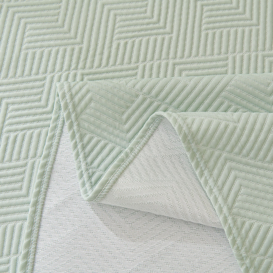 Mint Veil Artisan Cooling throw corner folded back to reveal the mesh underside and quilted top