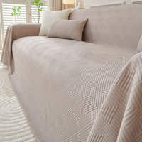 Angled close view of the Shell Taupe Artisan Cooling throw over a sofa corner, quilted diamond texture