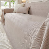 Angled close view of the Shell Taupe Artisan Cooling throw over a sofa corner, quilted diamond texture