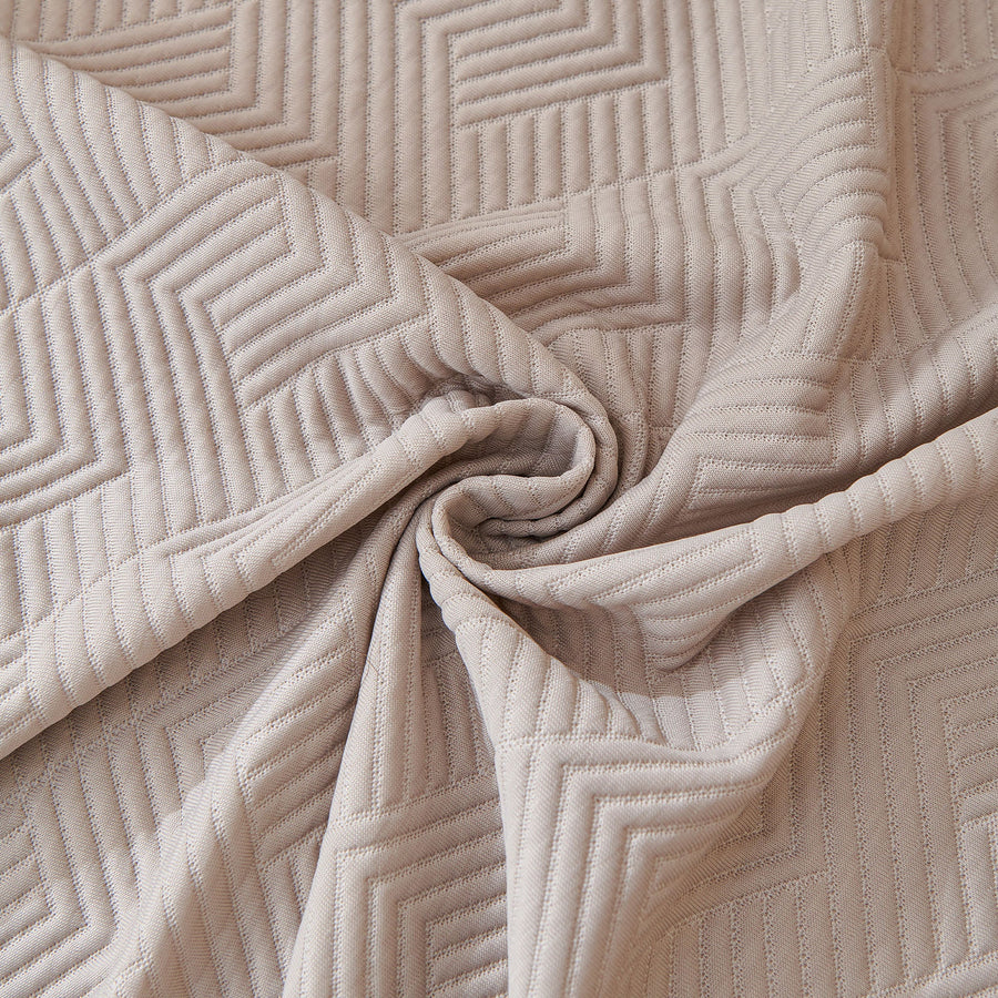 Macro swirl of the Shell Taupe Artisan Cooling fabric showing quilted geometric stitching