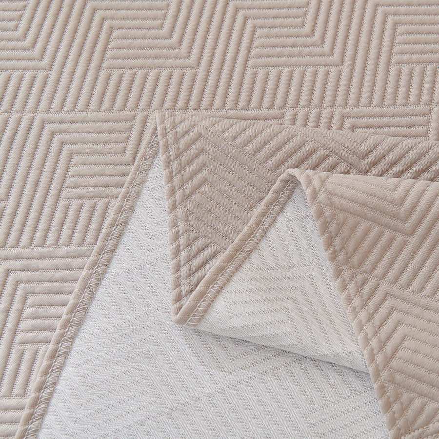 Flat detail of the Shell Taupe Artisan Cooling throw, folded corner revealing the woven reverse side