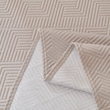 Flat detail of the Shell Taupe Artisan Cooling throw, folded corner revealing the woven reverse side