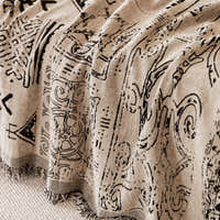 Macro of the sand beige fabric showing hand-drawn black artisan glyphs