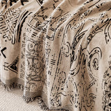 Macro of the sand beige fabric showing hand-drawn black artisan glyphs