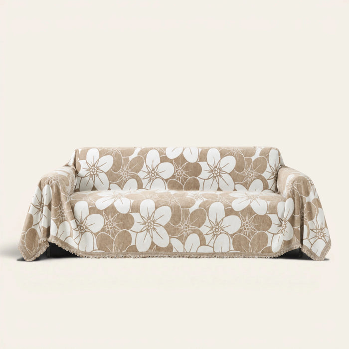 Mocha Latte Bloom Elegance sofa throw draped over a two-seat sofa, front view on ivory background, large white floral pattern