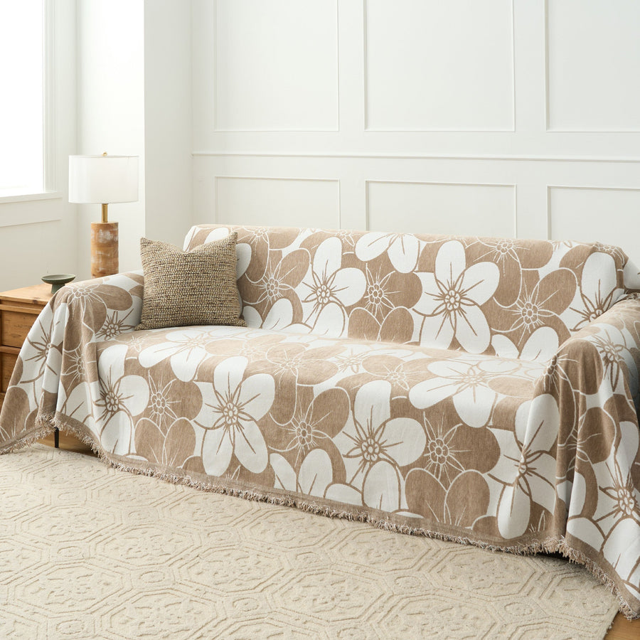 Mocha Latte Bloom Elegance throw over a sofa seat and arm with a floor lamp and patterned rug