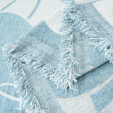 Close-up of the fringed corner of the Ocean Bloom Bloom Elegance floral throw