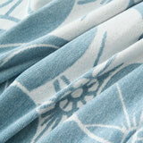 Macro of the Ocean Bloom woven fabric showing white blooms on soft blue