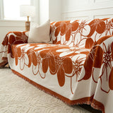 Bloom Elegance floral throw on a sofa with striped cushion and lamp in a bright room