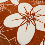 Macro of the rustic blossom pattern showing rust and cream retro flowers