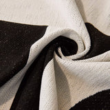 Macro close-up of the graphic harmony throw's woven texture swirled to show its black and white weave