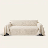 Breeze Lattice sofa throw in Ivory Pearl draped over a couch, front view on ivory background