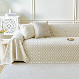 Ivory Pearl Breeze Lattice throw styled on a sofa with cushions in a bright living room