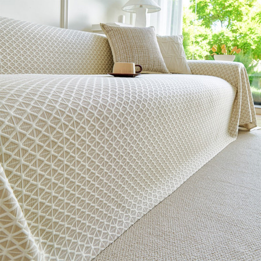 Ivory Pearl Breeze Lattice throw draped over a sofa corner, close angle showing the lattice weave