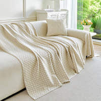 Ivory Pearl Breeze Lattice throw draped over a sofa arm by a bright window, side view