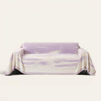 Lavender Drift Brushwave Chenille sofa throw draped over a two-seat sofa, front view on ivory background, pink fringed hem
