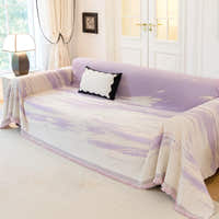 Lavender Drift Brushwave Chenille throw over a sofa in a bright paneled room with a cushion and lamp