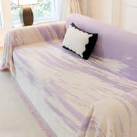 Angled view of Lavender Drift Brushwave Chenille throw on a sofa seat, soft brushstroke waves and cushion