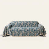 Classic Floral sofa throw in Blue Bouquet over a couch, front view with blue tapestry florals and fringe