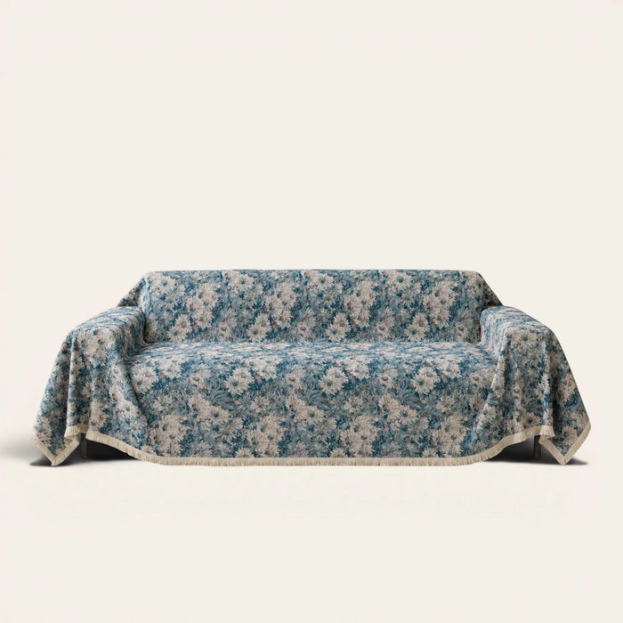 Classic Floral sofa throw in Blue Bouquet over a couch, front view with blue tapestry florals and fringe